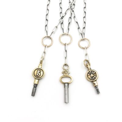 beautiful gold and silver antique pocket watch keys hanging on a 14kt gold loop from an oxidized sterling silver chain