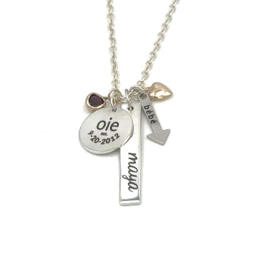 beautifully engraves charms featuring the names and birthdates of children, the family's last name est. with the wedding date, an arrow with the word bébé, a birthstone and gold heart